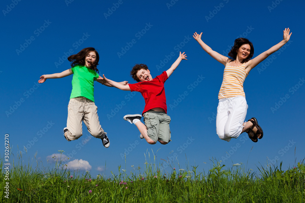 Active family - mother and kids jumping outdoor Active family - mother and kids jumping outdoor