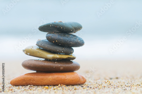 Stack of beach stones on sand. Harmony, life, balance