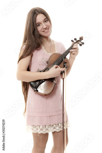 The young performer holds a violin and does pizzicato photo