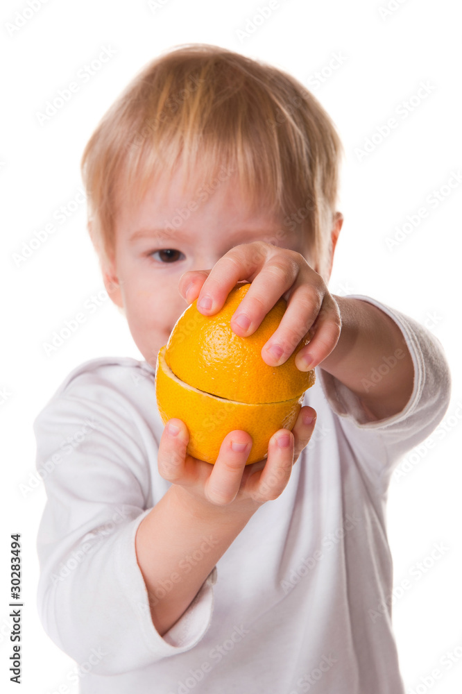 child holds half a lemon child holds half a lemon