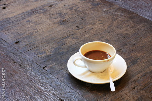 A cup of coffee on old wooden table