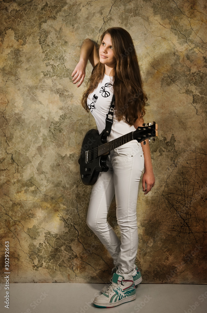 Teenager girl with electric guitar
