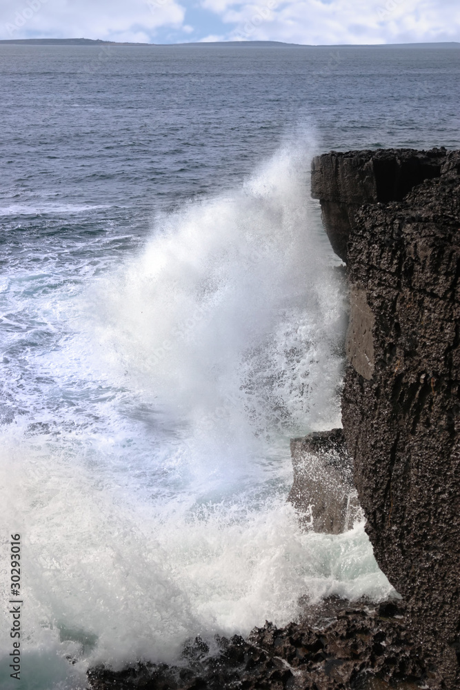 waves crashing on cliffs
