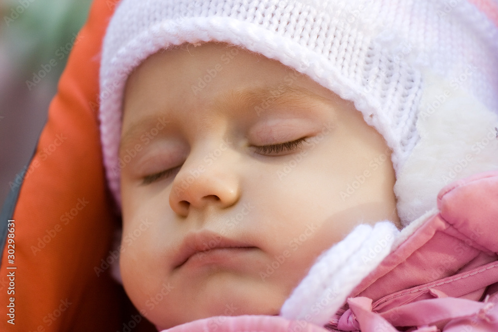 little girl in a pink jacket sleeps in a carriage little girl in a pink jacket sleeps in a carriage