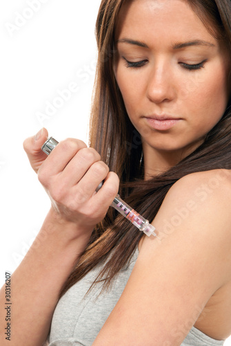 Woman making insulin flu shot by syringe pen