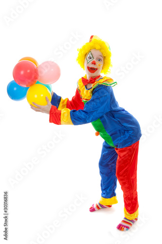 child dressed as colorful funny clown with balloons