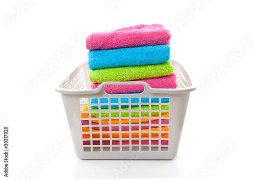 Laundry basket filled with colorful folded towels photo