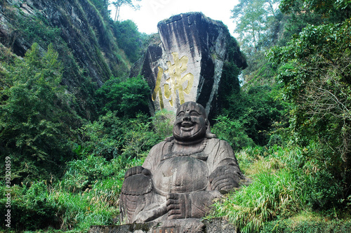 Statue of smiling buddha © bbbar