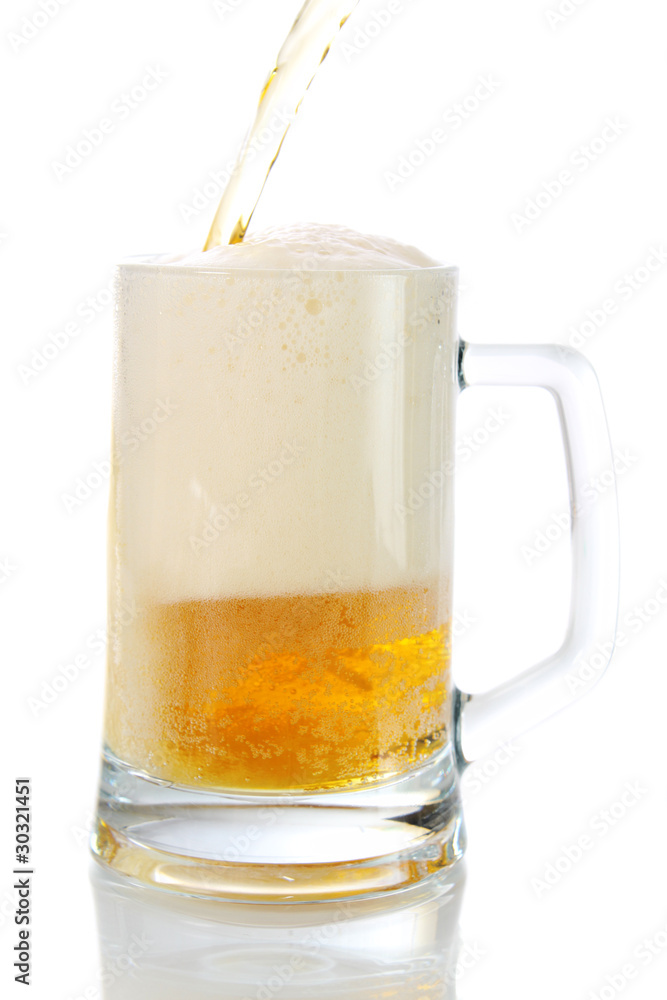 Beer flows from a bottle in a glass. Beer flows from a bottle in a glass.