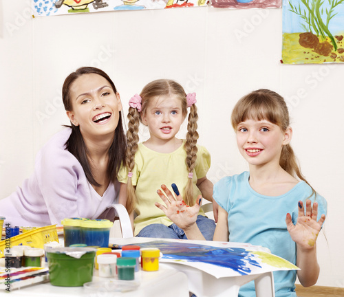 Children painting in preschool.