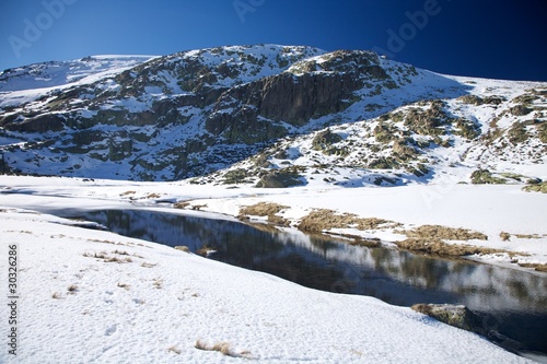 snow mountain river at gredos photo