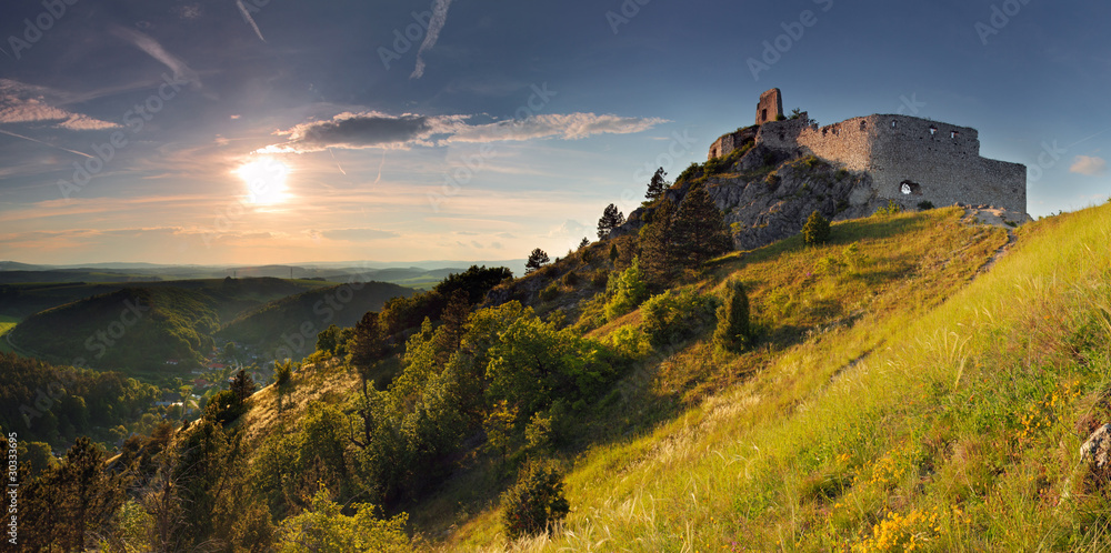 Naklejka premium Ruin of castle with sun