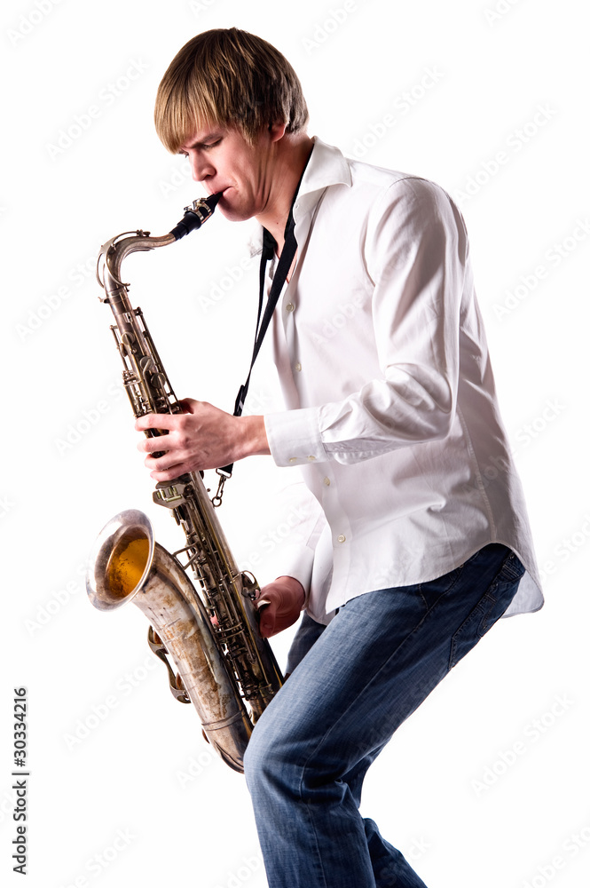 Naklejka premium Young man playing the saxophone over white background