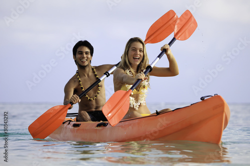 young couple with their kayak in hawaii