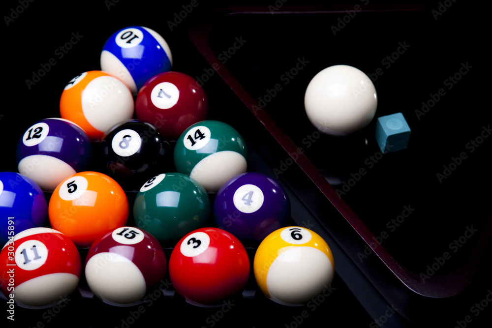 Billiard balls, cue on black table Billiard balls, cue on black table