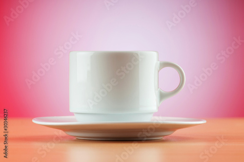 White cup against colourful gradient on the table