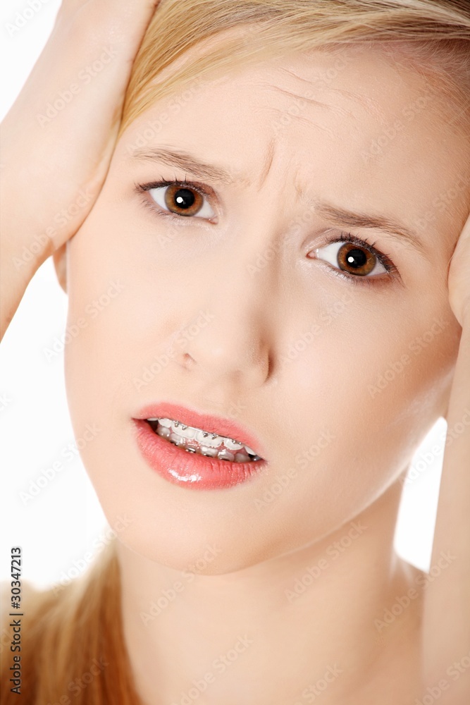 Obraz premium Woman with headache holding her hand to the head