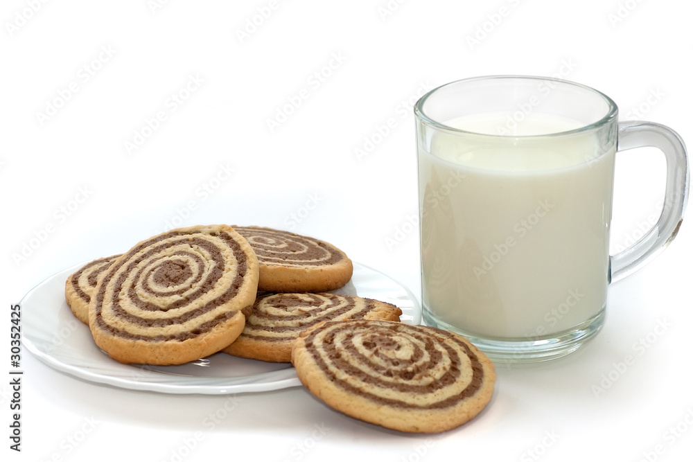 black and white cookies on the plate with cup of milk black and white cookies on the plate with cup of milk