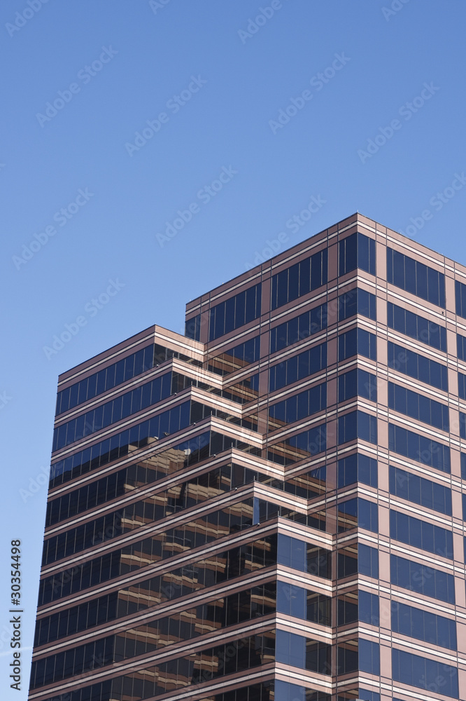 Office Tower of Brown and Black Glass on Blue Sky Office Tower of Brown and Black Glass on Blue Sky