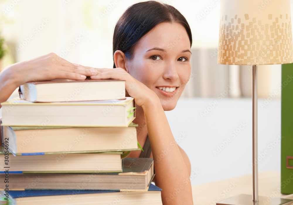 Cheerful young woman posing with books Cheerful young woman posing with books