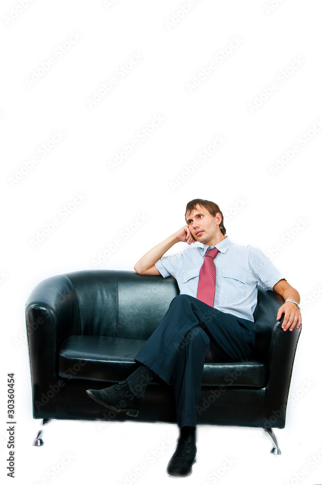 The businessman sits on a sofa