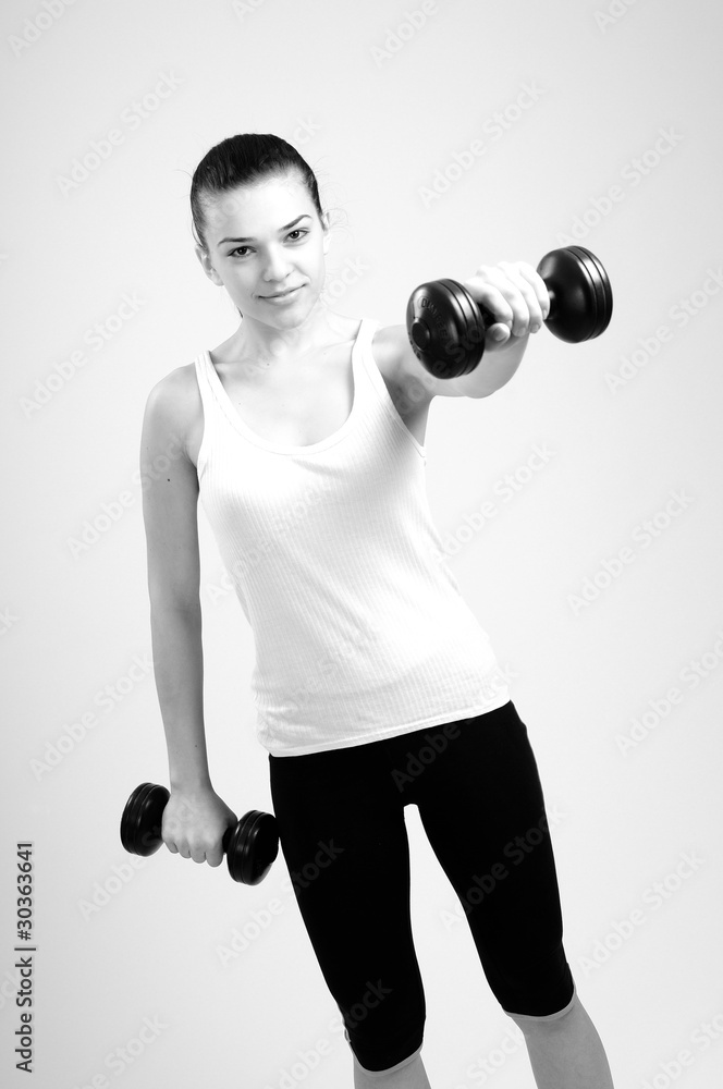 woman working out her hands muscles with dumbbell woman working out her hands muscles with dumbbell