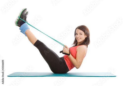 Attractive young female with fitness expander in stretching