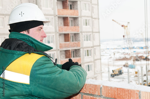 one builder foreman at construction site in winter