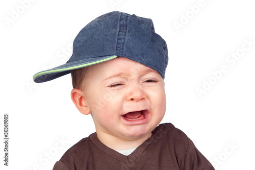Canvas Print Beautiful baby crying with a cap