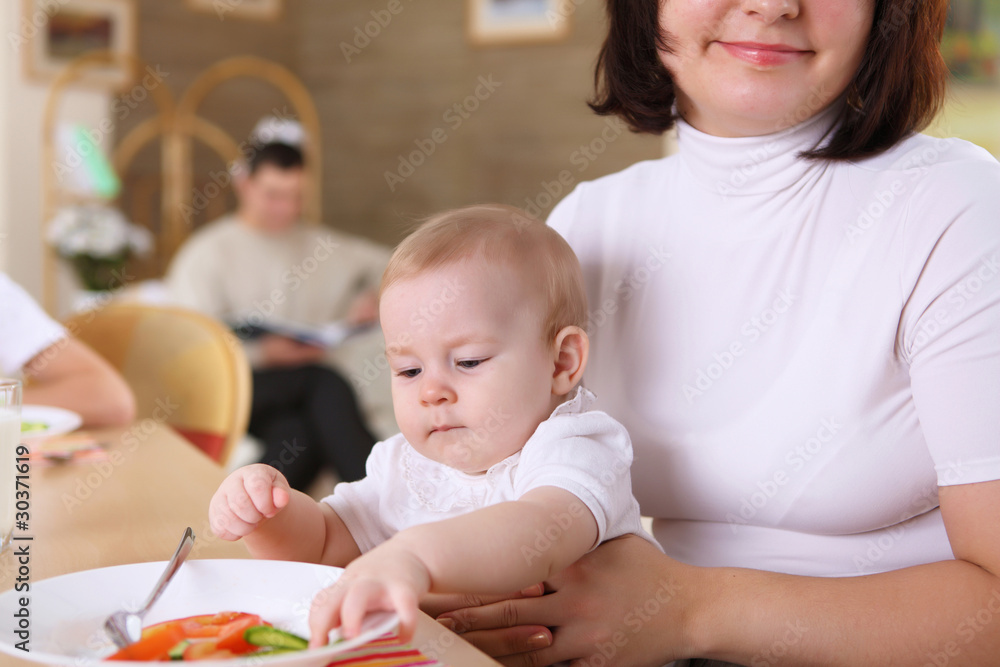 a young mother feeding her infant baby a young mother feeding her infant baby
