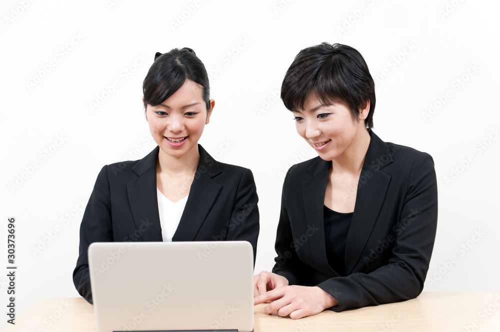two asian businesswomen working on the desk two asian businesswomen working on the desk