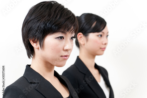 two asian businesswomen standing