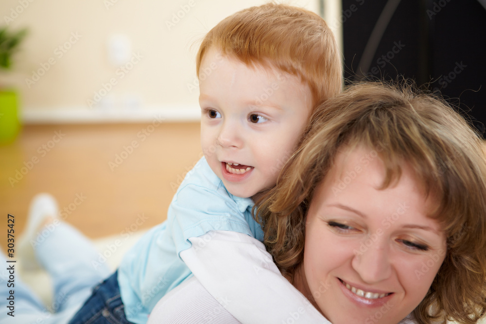 mother and son at home on the floor mother and son at home on the floor