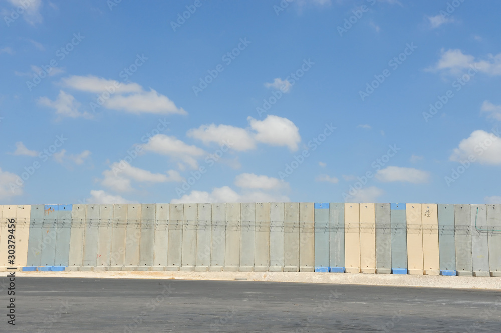 †Israeli West Bank†barrier†against cloudy sky