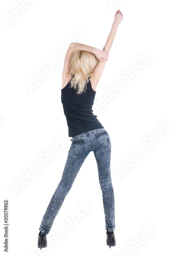 Young woman dancing. Rear view.