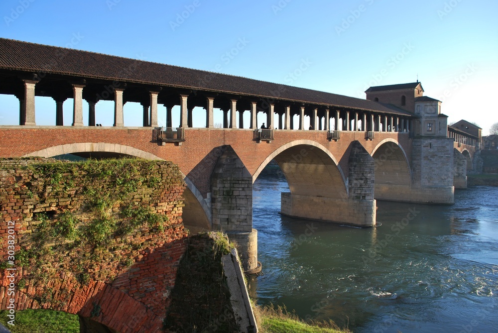Old covered bridge on Ticino river in Pavia, Lombardy, Italy