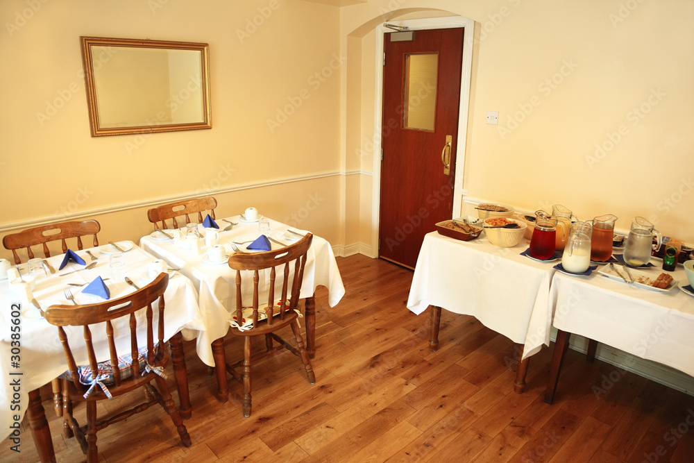 Small, cozy restaurant with food on table, buffet service Small, cozy restaurant with food on table, buffet service
