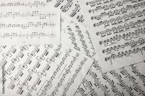 Print op canvas View of music notes on paper sheets