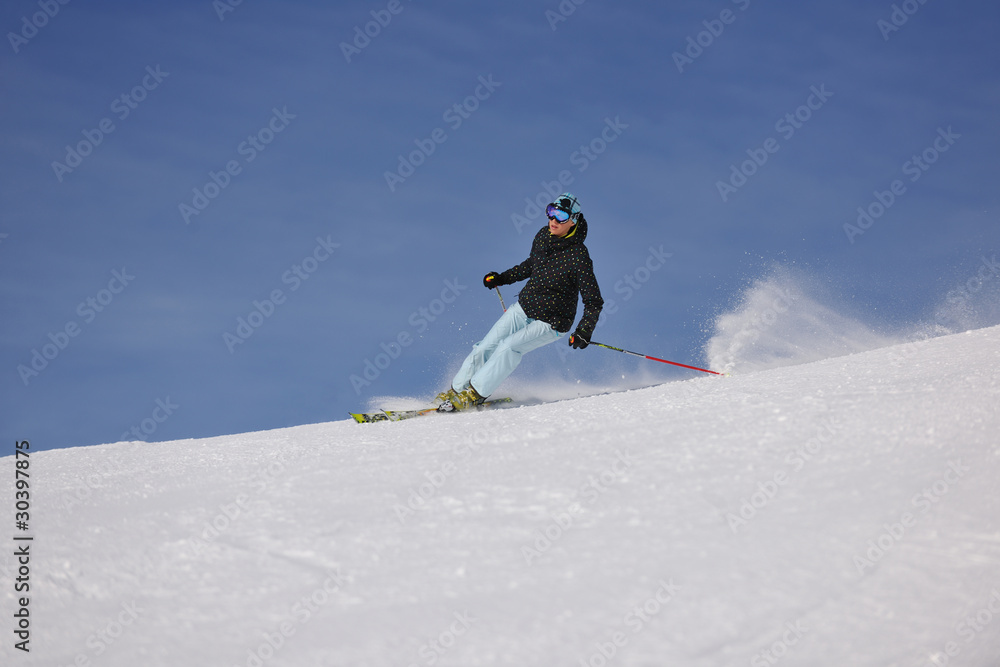 woman skiing on fresh snow at winter season