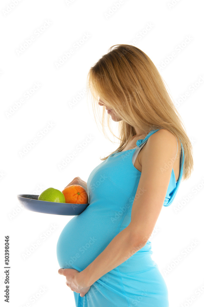 Pregnant holding an apple and an orange in a pan Pregnant holding an apple and an orange in a pan