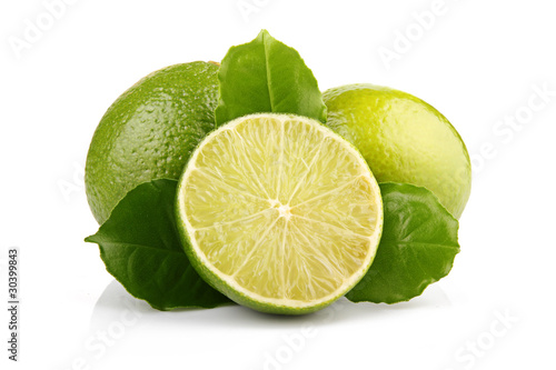 Ripe lime fruits with green leaves isolated