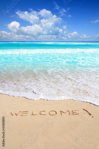 greetings welcome beach spell written on sand