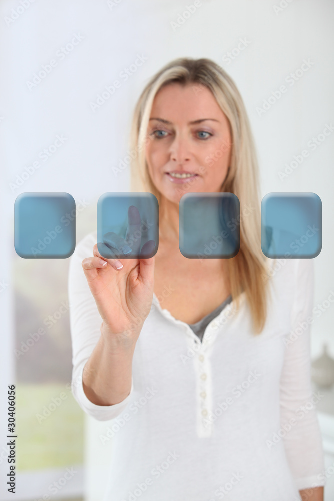 Blond woman touching virtual screen Blond woman touching virtual screen
