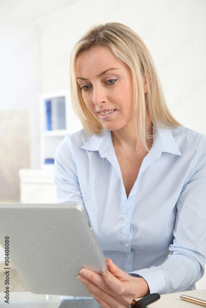 Portrait of office worker using electronic tablet in office Portrait of office worker using electronic tablet in office