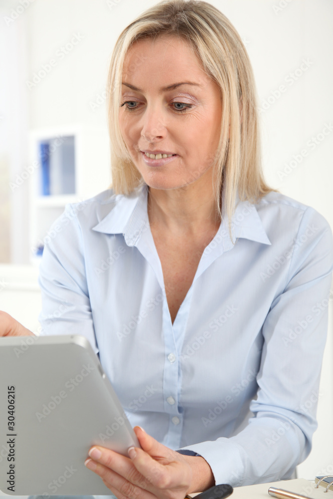 Portrait of office worker using electronic tablet in office Portrait of office worker using electronic tablet in office