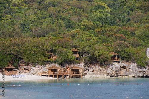 Wood Cabanas Along Lush Tropical Coast