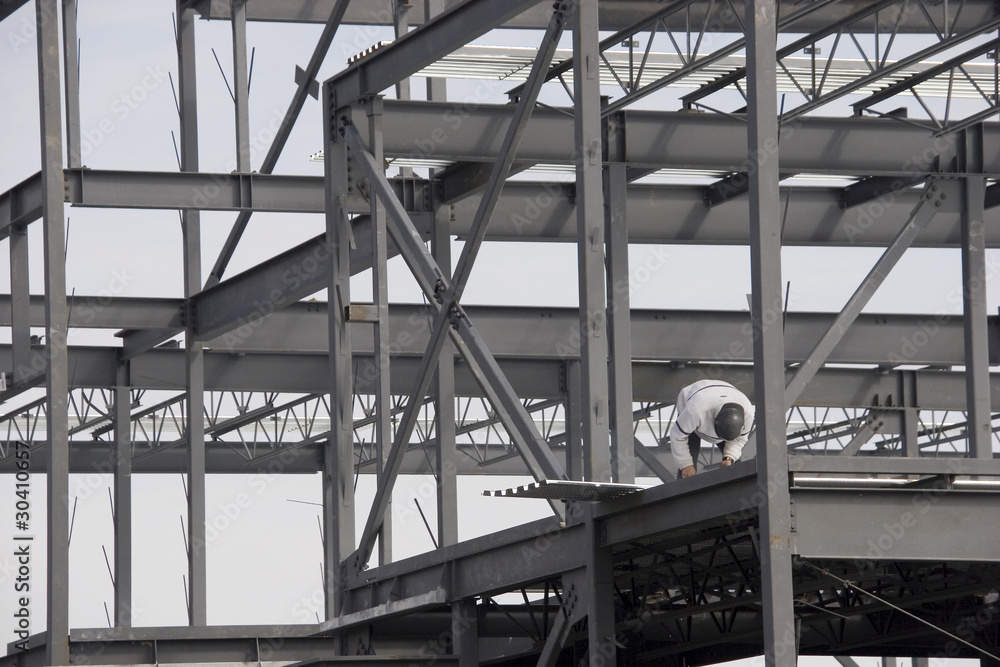 Construction worker building steel framing Construction worker building steel framing