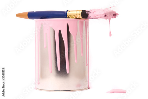 Can of pink paint and professional brush on a white