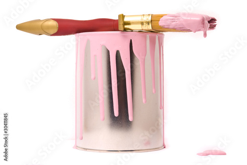 Can of pink paint and professional brush on a white