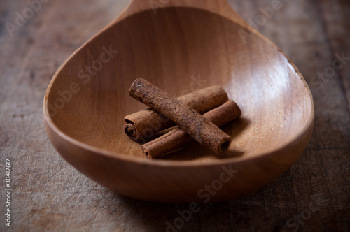 cinnamon stiks in a wooden spoon